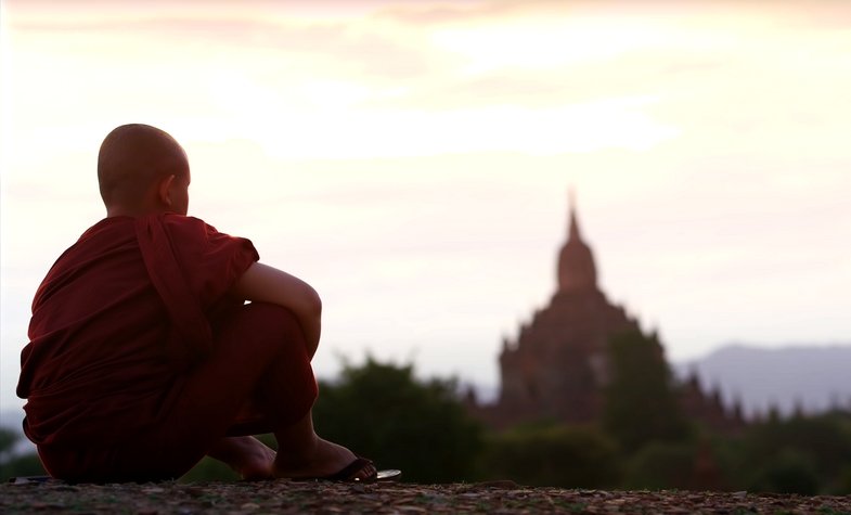 a monk watching the sun rise