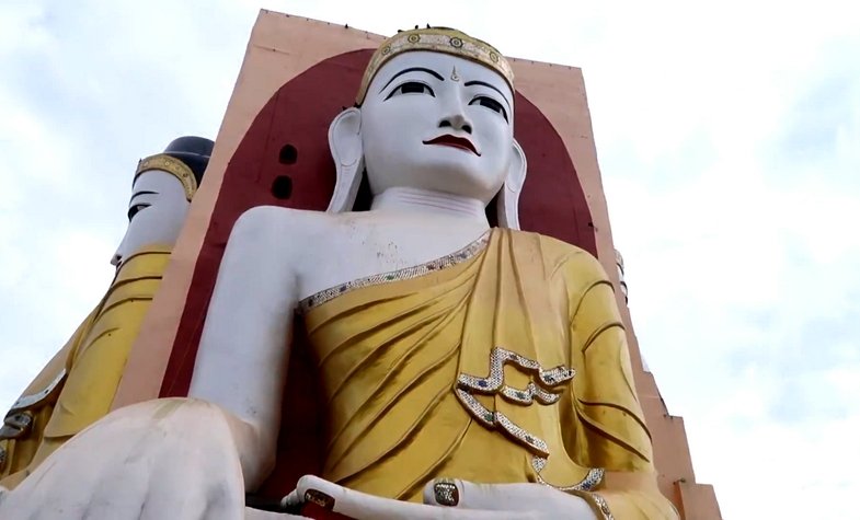 Four 27-meter-height Budhha statues lean against a pillar at Kyaik Pun Pagoda