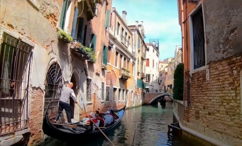 Gondola boat rowing in Venice