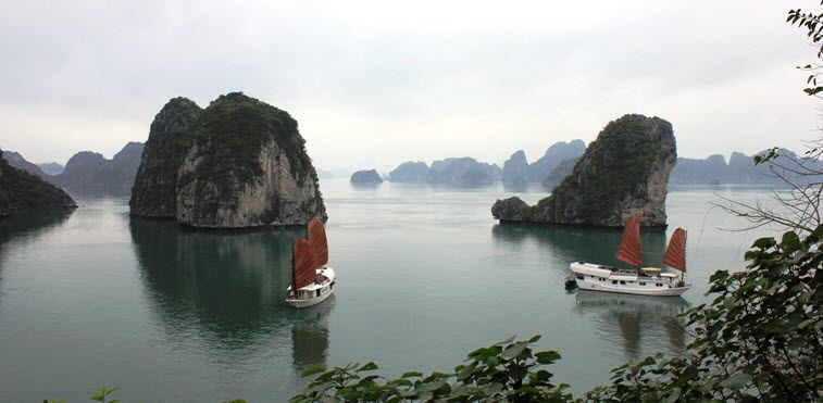 Ha Long Bay, with two boats are wadering around two small islands