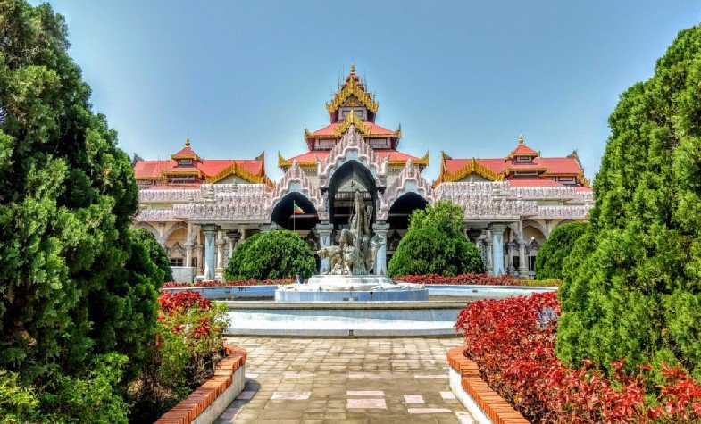 a water fountain in front of white and red Bagan Archaeological Museum