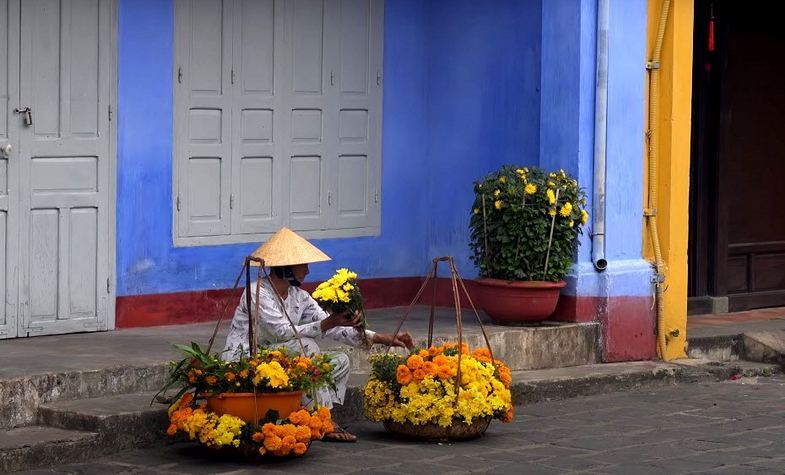 lady and her flower vendor in Hoi An, Vietnam