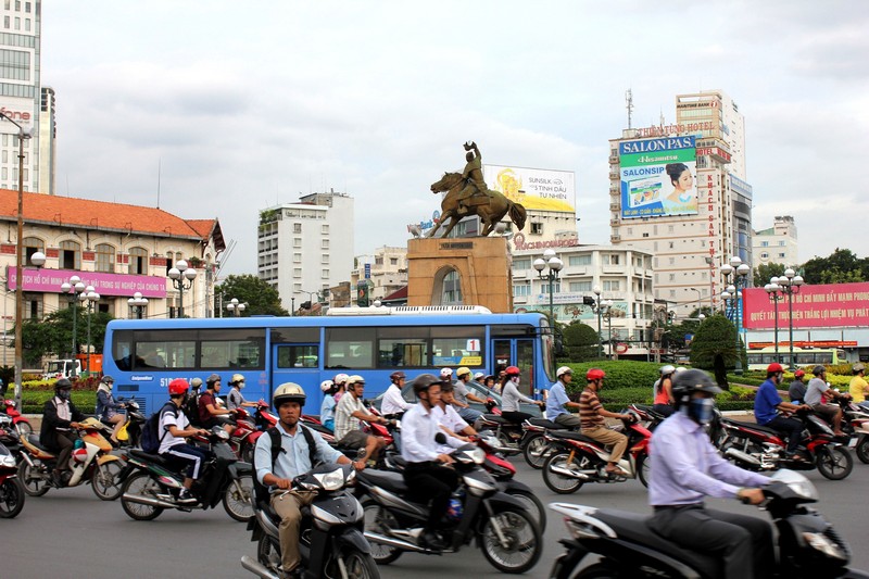 crowded street with many motorcycle during peak hours at the central hall of Ho Chi Minh city